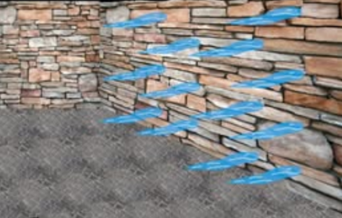 a stone wall with spikes of ice sticking off of the side of it in a pattern reminiscent of a pachinko board